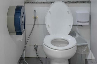 a public toilet with comprehensive hygiene equipment, from toilet roll dispenser, spray jet, sanitary trash bin to automated urinary hygiene service