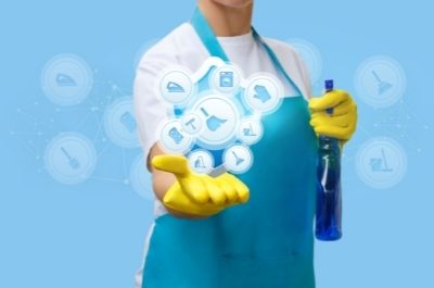 a cleaner in blue apron illustrating types of cleaning services available